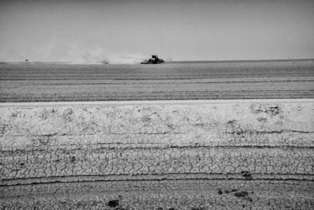Corcoran California, August 27, 2014:  A tractor tills dry land near the Tulare Lake basin. © Matt Black.